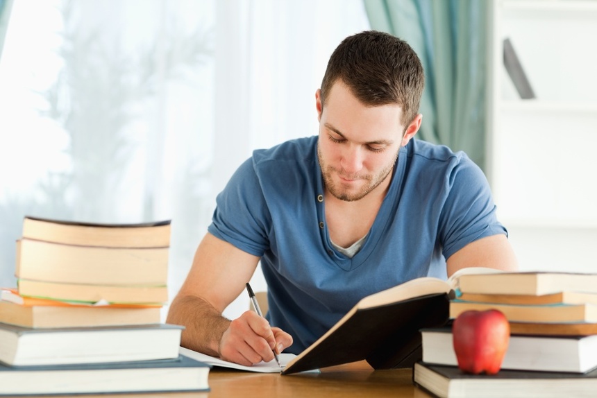 Male student working through his books 1