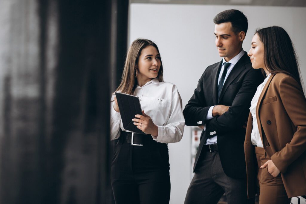 male and female business people working on tablet in office scaled